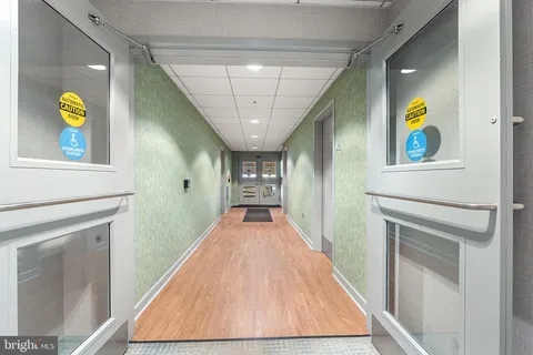 a view of a street with a building and trees in the background