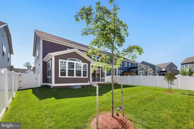 an aerial view of residential houses with outdoor space and swimming pool