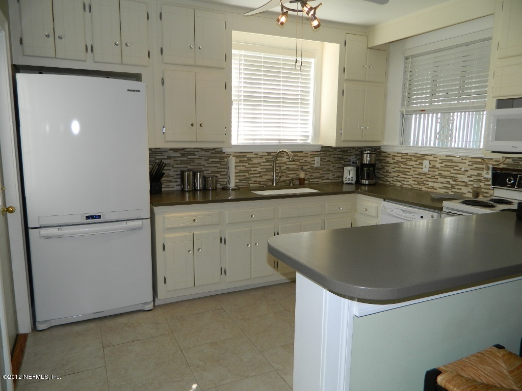 2231 Southampton Road Jacksonville, FL 32207 - Photo 7 of 23 a kitchen with stainless steel appliances granite countertop a sink a stove and a refrigerator
