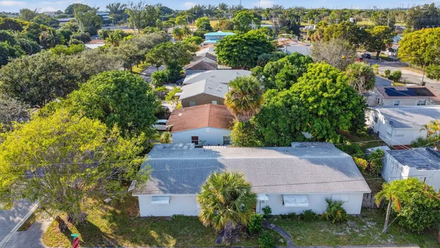 an aerial view of a house with a yard and garden