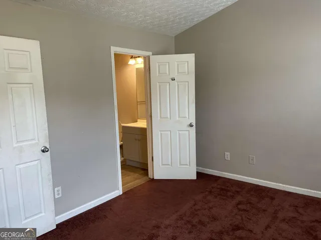 an empty room with closet area