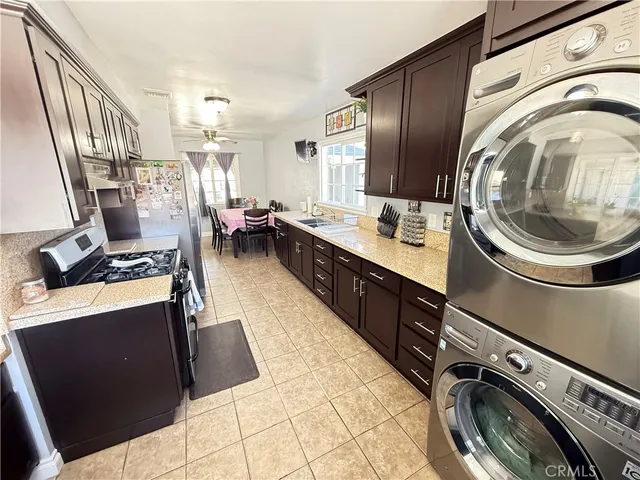 a kitchen with granite countertop a refrigerator and a sink