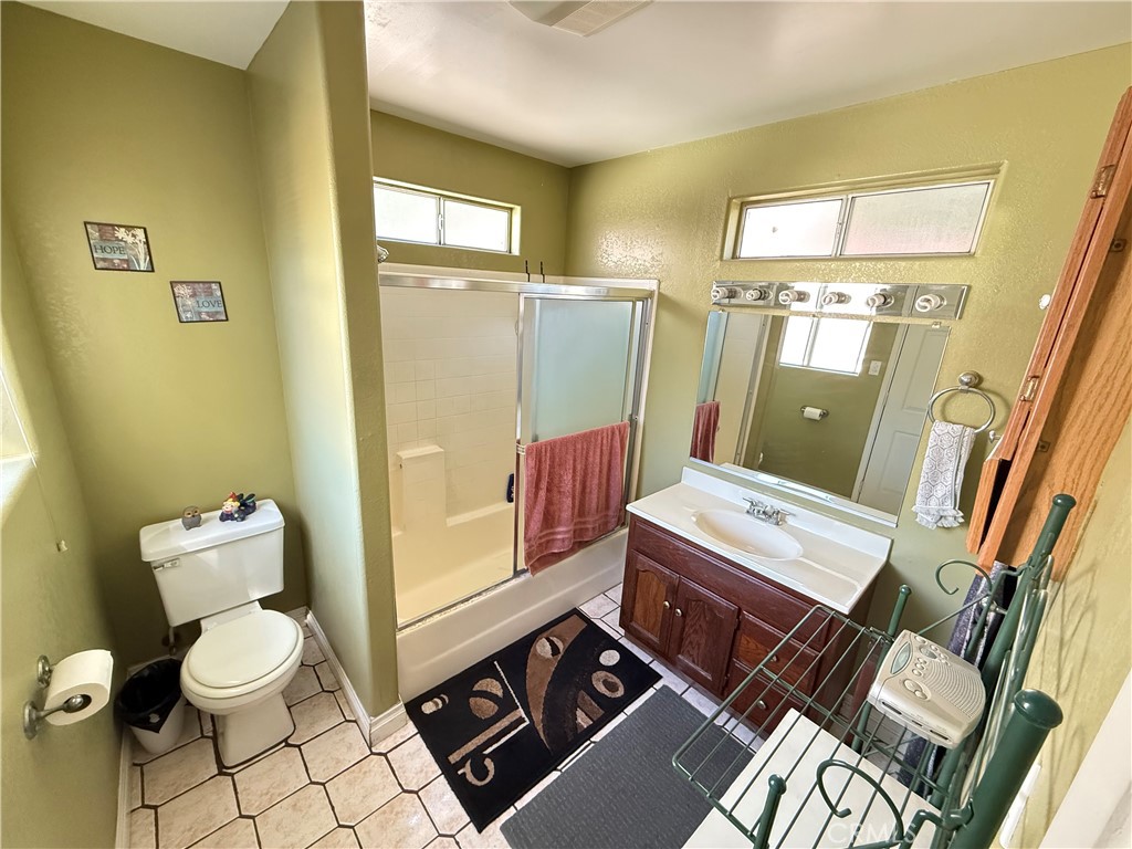 10430 McVine Avenue Sunland, CA 91040 - Photo 36 of 52 a bathroom with a sink mirror vanity and toilet