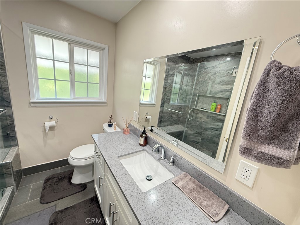 10430 McVine Avenue Sunland, CA 91040 - Photo 42 of 52 a bathroom with a double vanity sink toilet and shower