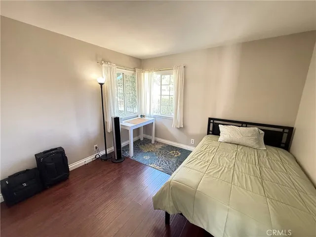 a bedroom with a bed and a mirror