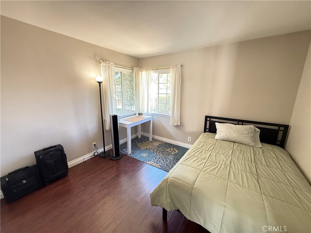 10430 McVine Avenue Sunland, CA 91040 - Photo 44 of 52 a bedroom with a bed a table and a potted plant