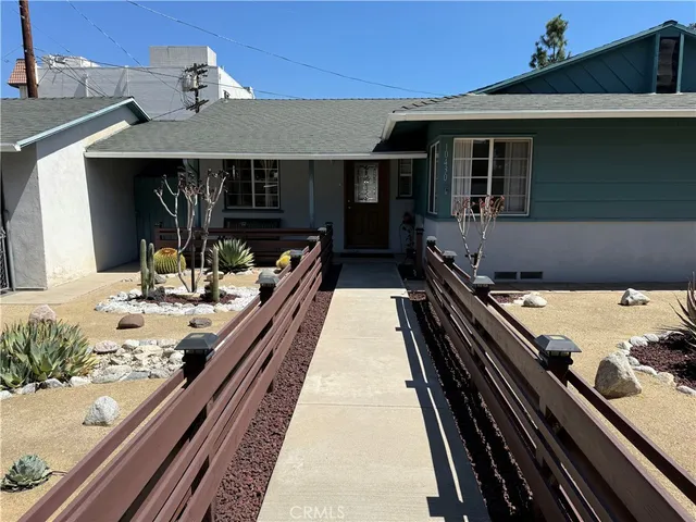 a view of a patio with two couches and wooden floor