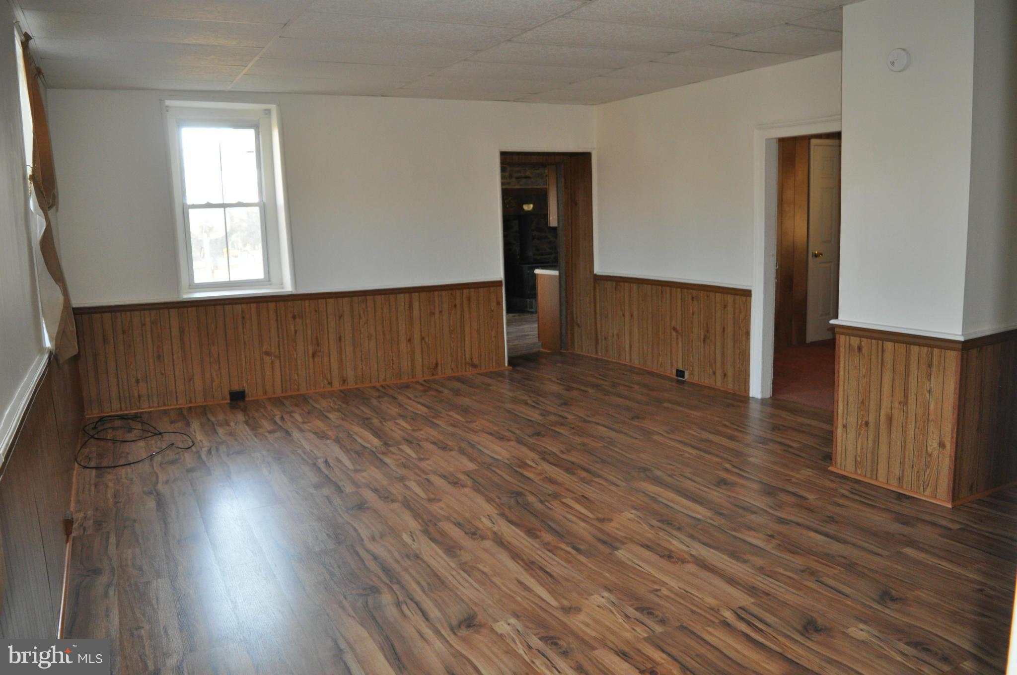 7234 Tommytown Road Sharpsburg, MD 21782 - Photo 13 of 40 an empty room with wooden floor and windows