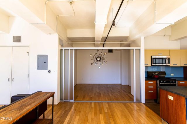 a view of a porch with wooden floor and furniture
