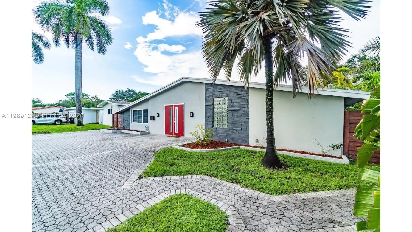 3161 Riverland Road Fort Lauderdale, FL 33312 - Photo 1 of 25 a front view of a house with garden