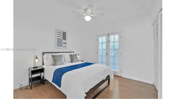 a bed room with a bed and a chandelier