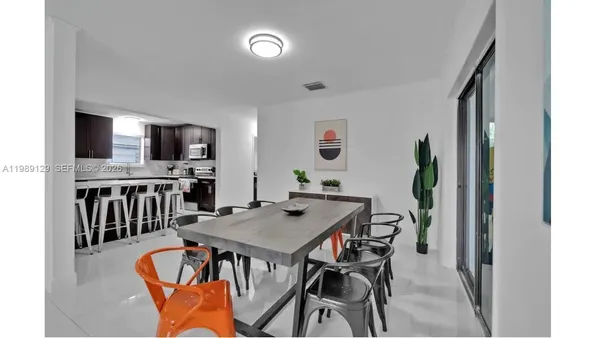 a view of a dining room with furniture and a kitchen
