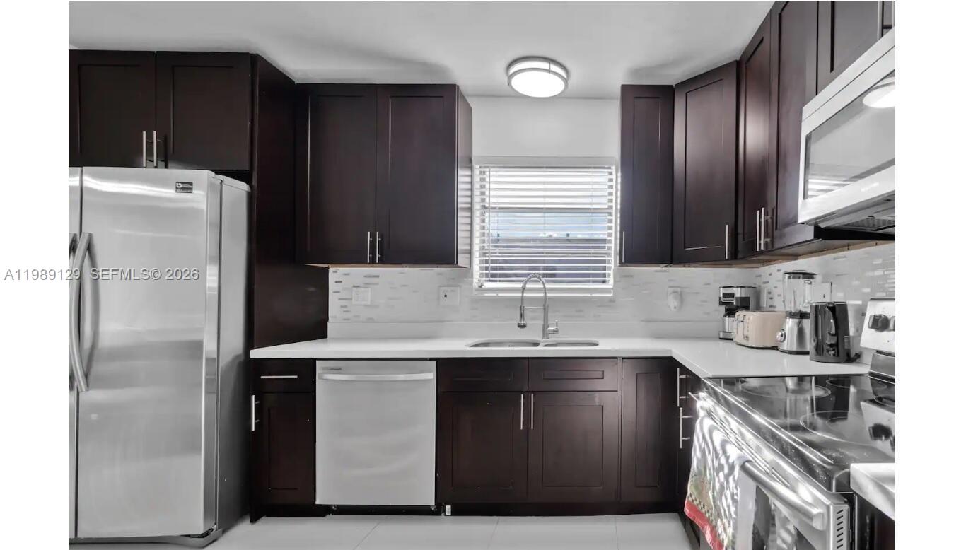 3161 Riverland Road Fort Lauderdale, FL 33312 - Photo 21 of 25 a kitchen with stainless steel appliances a sink stove and refrigerator