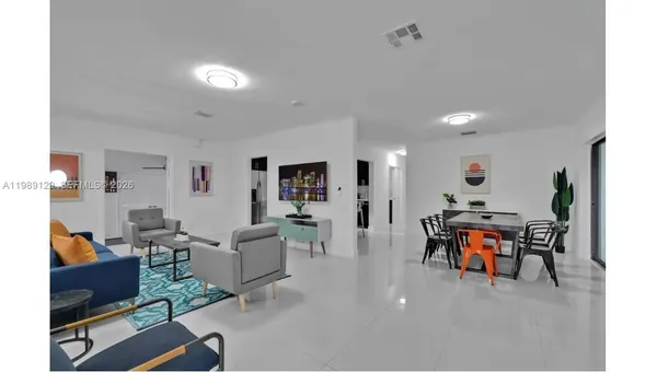 a living room with furniture and a dining table