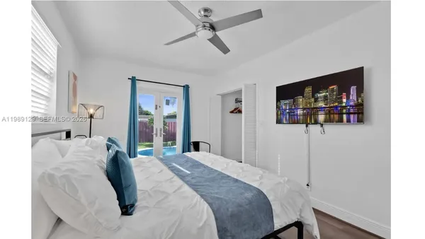 a bedroom with a bed and a flat screen tv