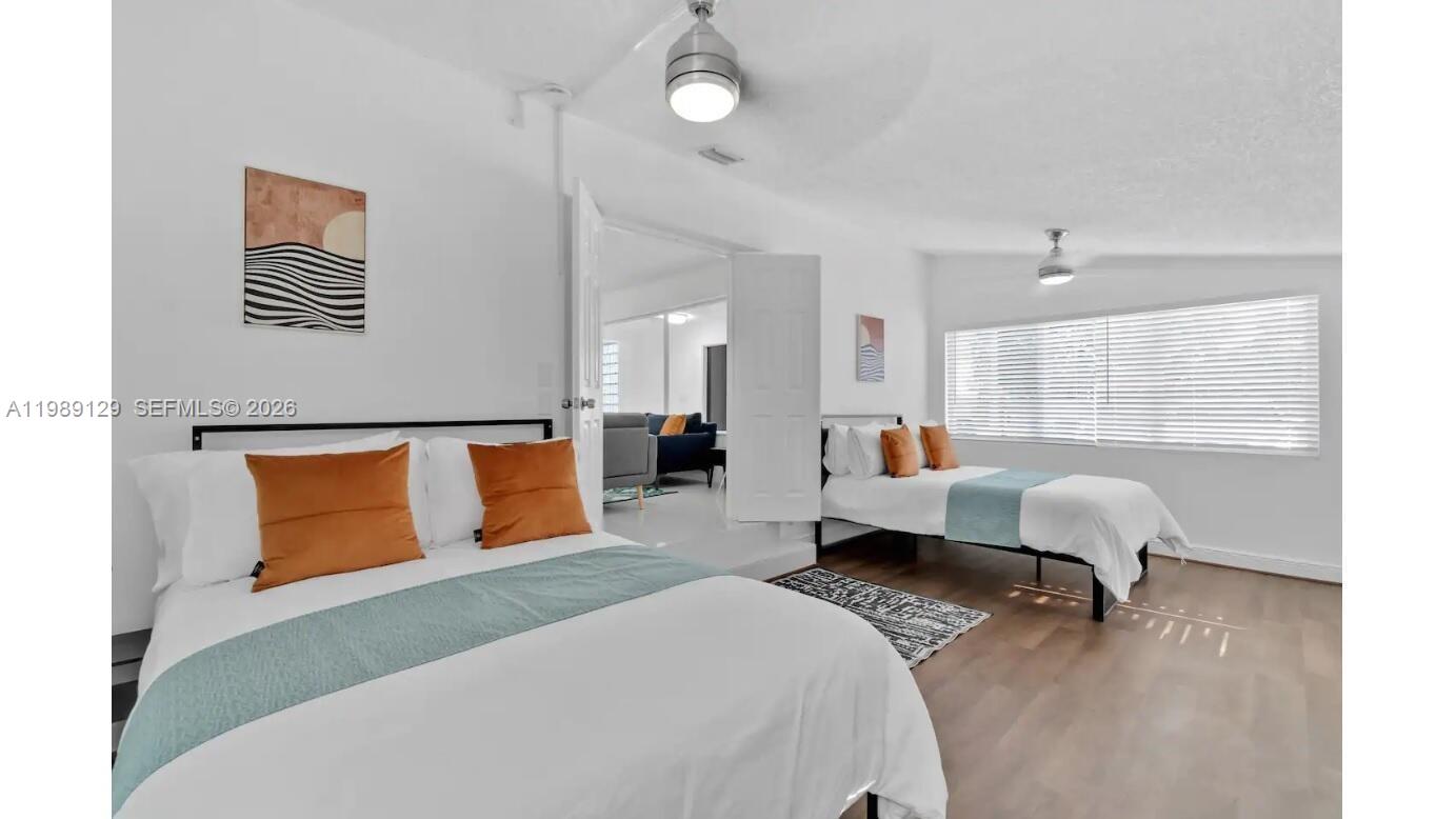 3161 Riverland Road Fort Lauderdale, FL 33312 - Photo 10 of 25 a bedroom with a bed and wooden floor