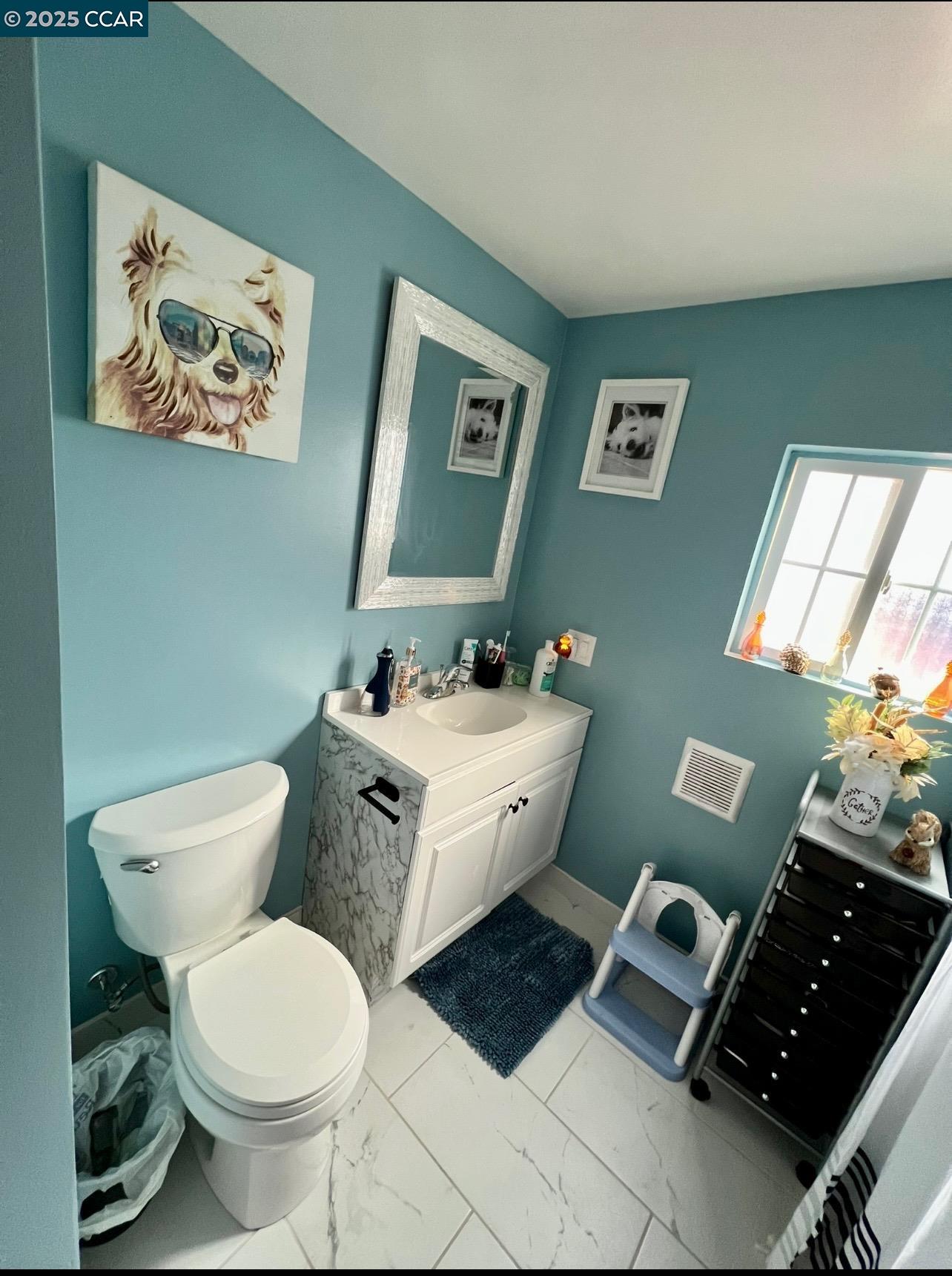 1526 Willow Pass Road, Unit 16 Pittsburg, CA 94565 - Photo 8 of 10 a bathroom with a toilet sink and mirror