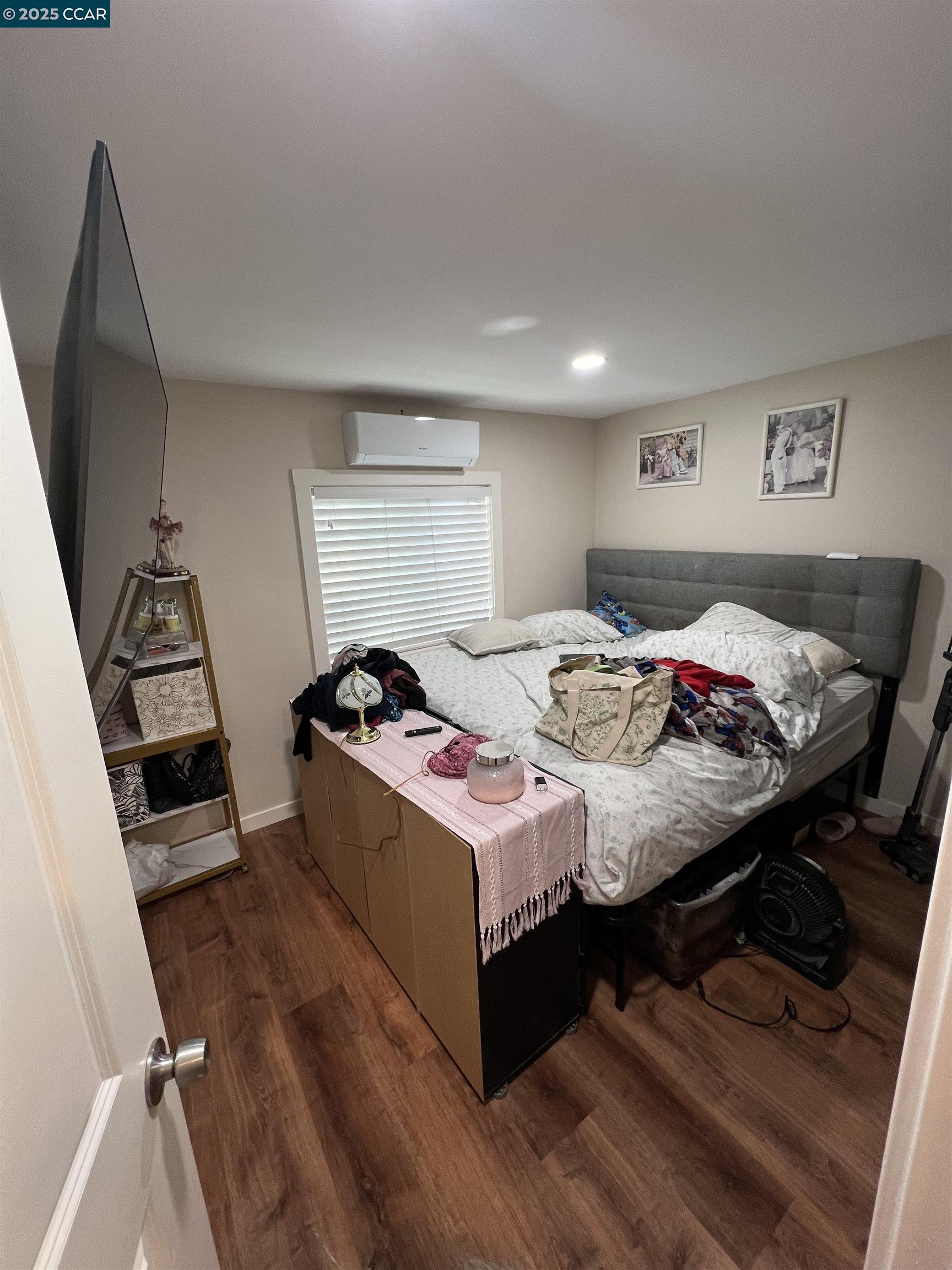 1526 Willow Pass Road, Unit 16 Pittsburg, CA 94565 - Photo 9 of 10 a bed room with a bed and a television