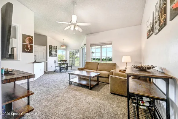 a living room with furniture and a chandelier