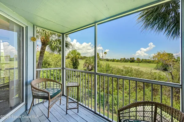 a view of a balcony with furniture