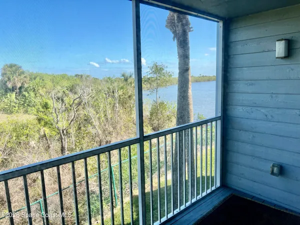 a view of a balcony with furniture