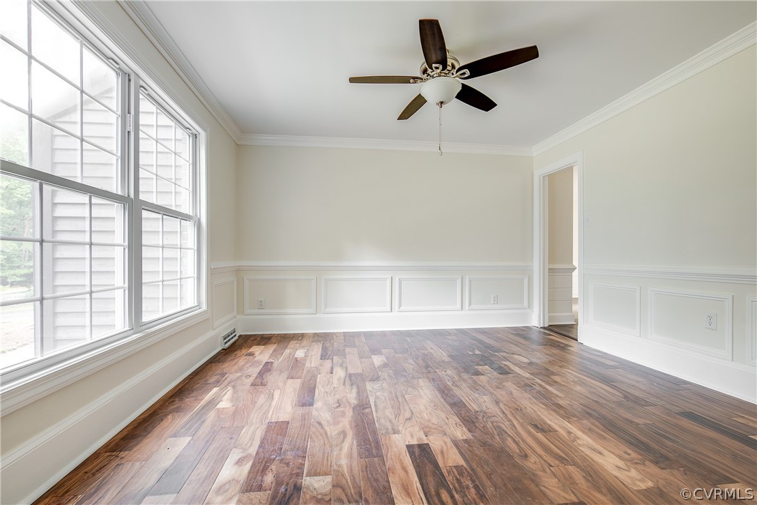 9340 Cardiff Loop Road North Chesterfield, VA 23236 - Photo 6 of 36 an empty room with wooden floor fan and windows