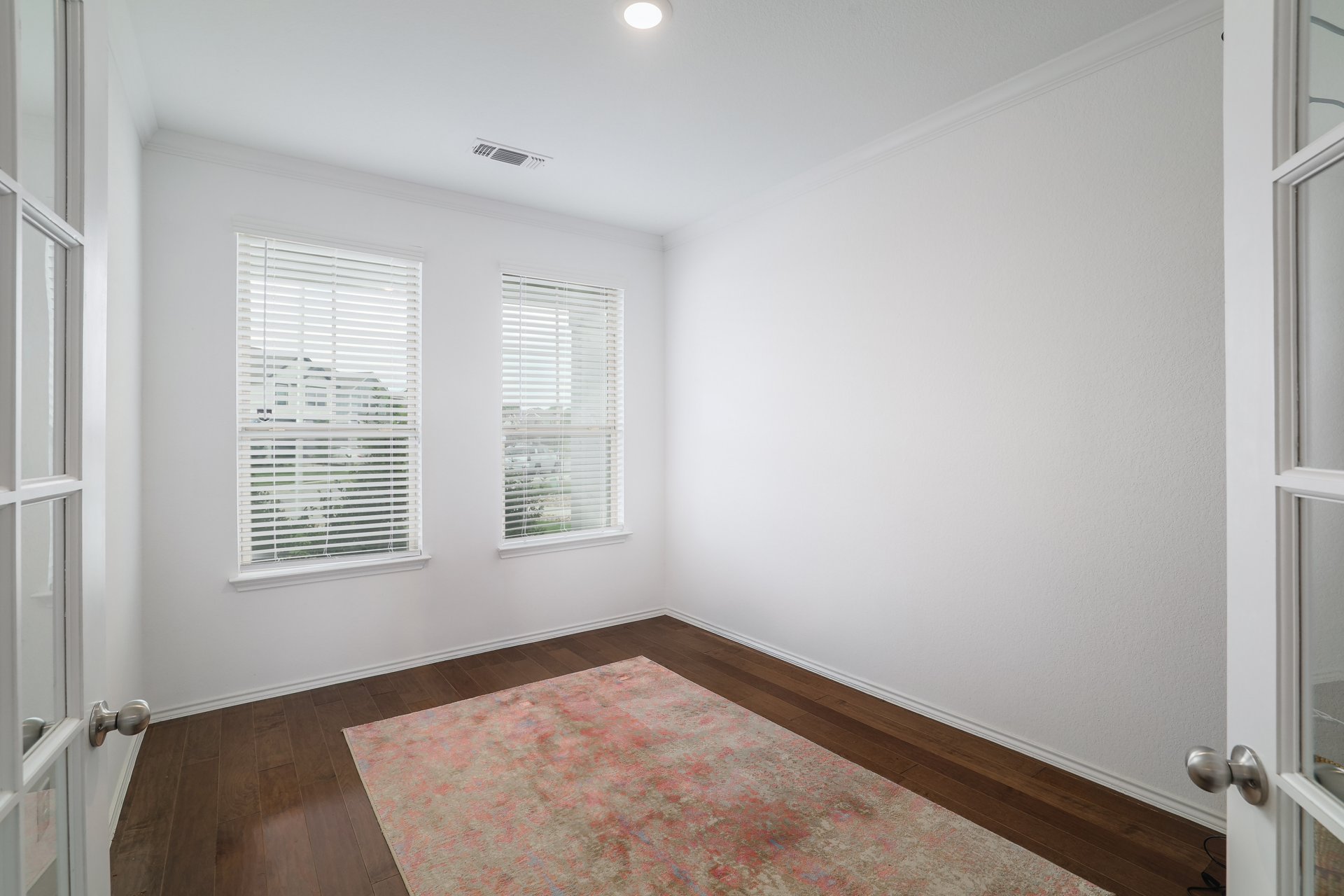 6829 Ellsworth Walk Austin, TX 78724 - Photo 12 of 32 Study with wood flooring and french doors.