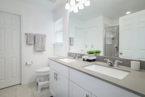a bathroom with a granite countertop sink and a bathtub