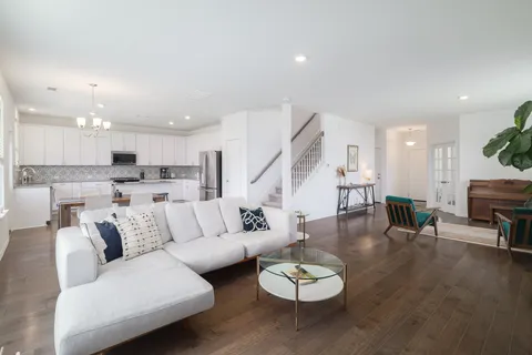 a dinning room with furniture kitchen view and a wooden floor