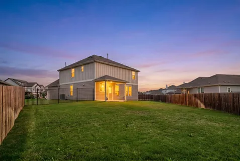 an aerial view of residential houses with yard