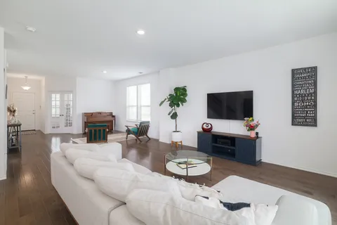 a living room with furniture a fireplace and a window