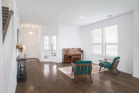 a kitchen with stainless steel appliances a table chairs refrigerator and cabinets