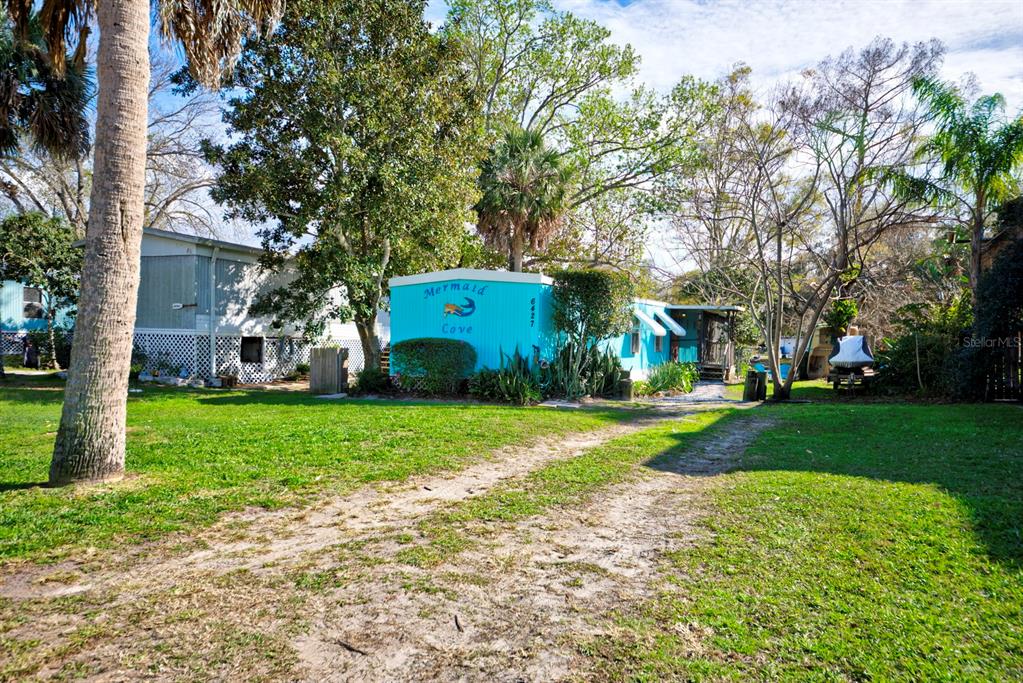 6427 West Richard Drive Weeki Wachee, FL 34607 - Photo 29 of 35 a front view of a house with garden