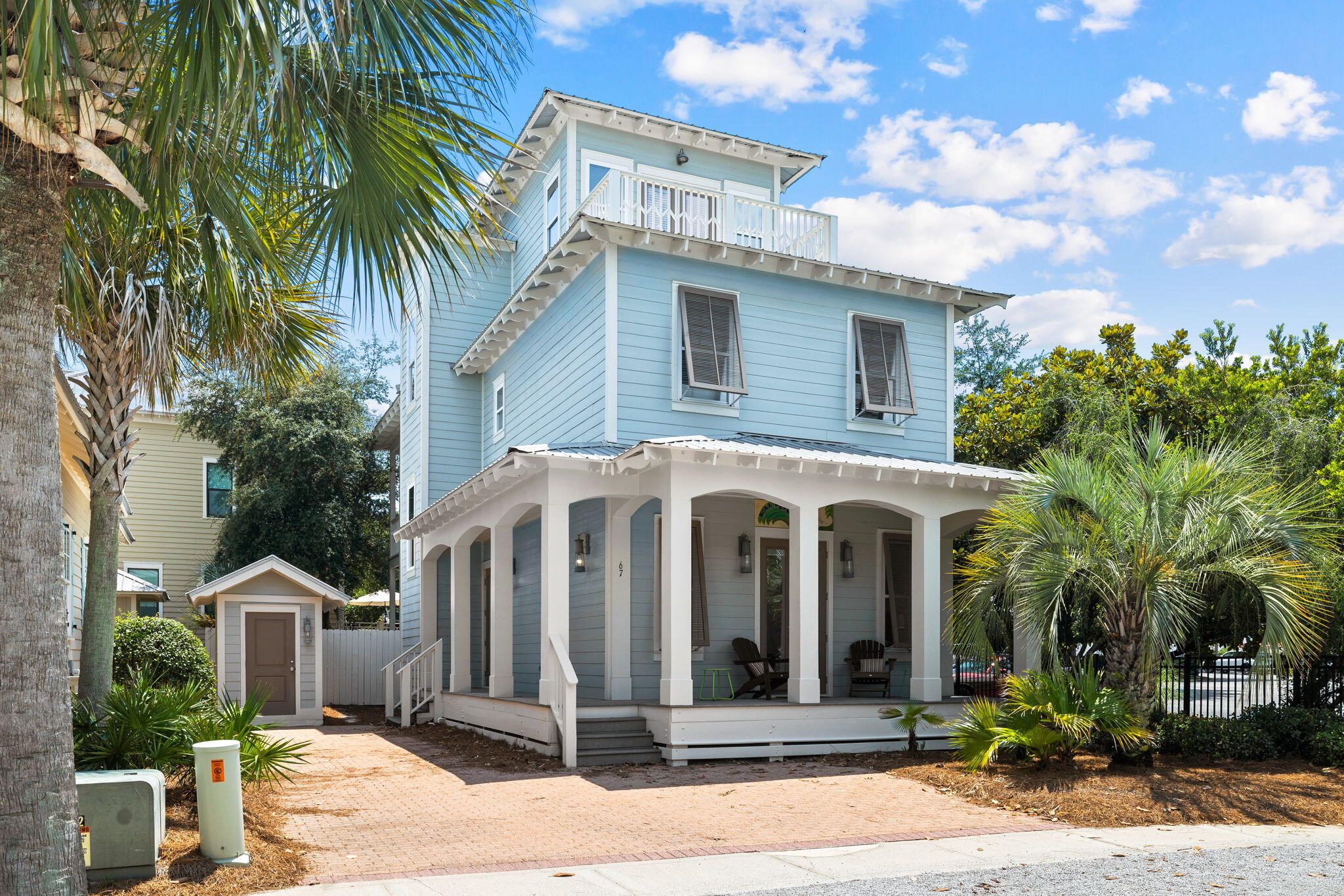 a front view of a house with a garden