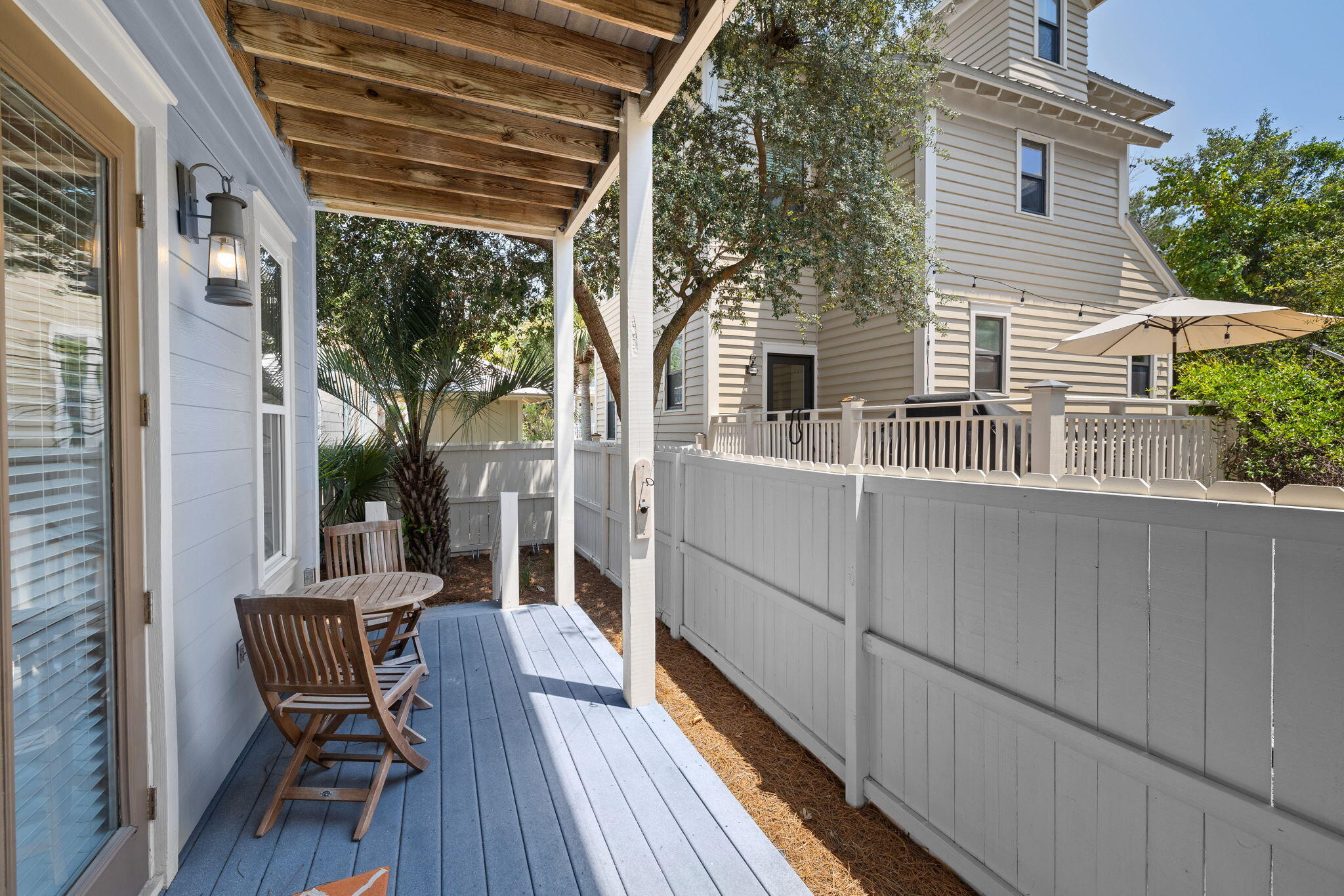 67 West Blue Crab Loop Inlet Beach, FL 32461 - Photo 58 of 78 a view of a patio with table and chairs and wooden floor