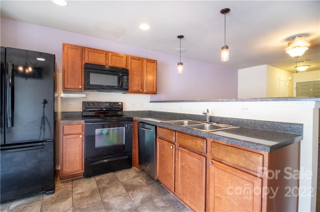662 Potter Place Road Fort Mill, SC 29708 - Photo 11 of 28 a kitchen with stainless steel appliances granite countertop a sink and a stove