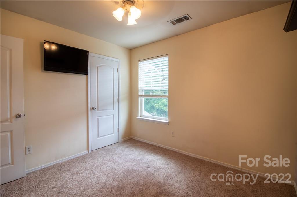 662 Potter Place Road Fort Mill, SC 29708 - Photo 17 of 28 a view of an empty room with a window and a flat screen tv
