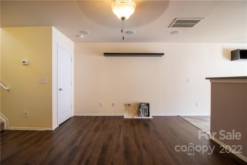 662 Potter Place Road Fort Mill, SC 29708 - Photo 6 of 28 an empty room with wooden floor and cabinet