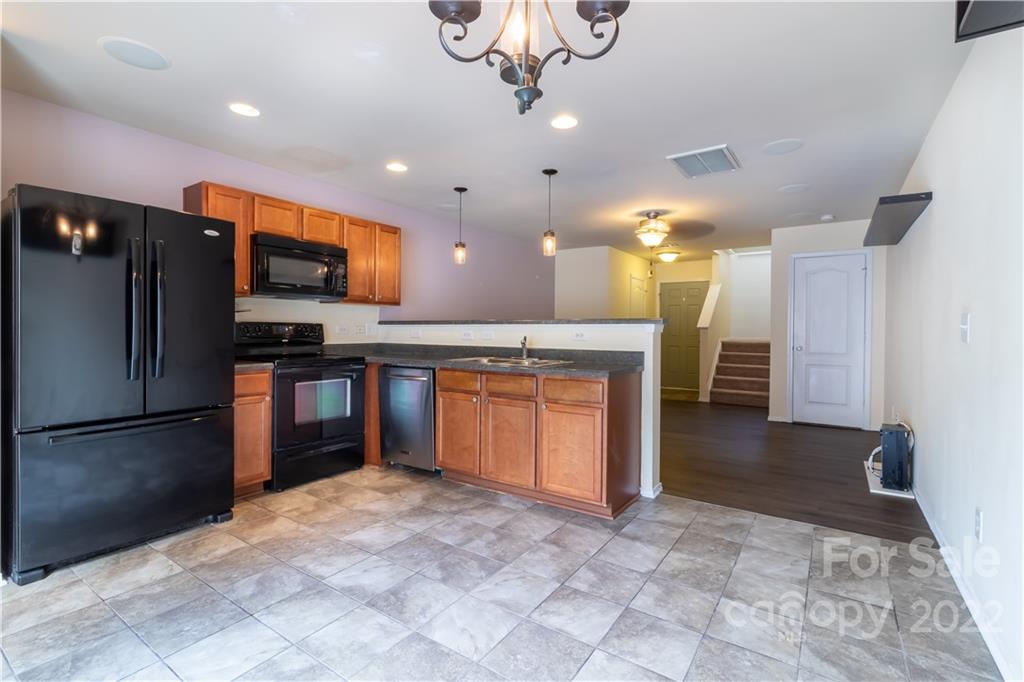 662 Potter Place Road Fort Mill, SC 29708 - Photo 10 of 28 a large kitchen with a refrigerator and a stove top oven