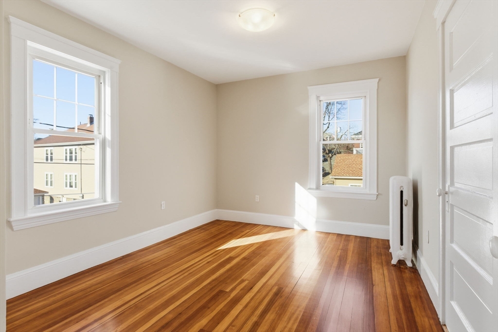113 Minot Street, Unit 2 Boston, MA 02122 - Photo 22 of 34 a view of empty room with wooden floor and fan