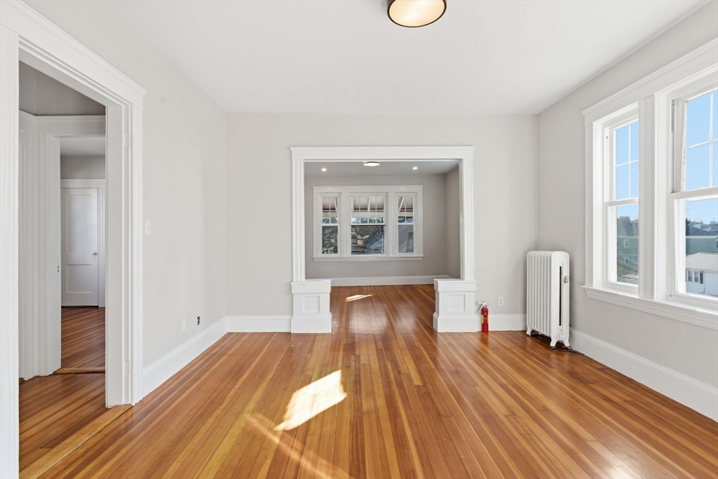 113 Minot Street, Unit 2 Boston, MA 02122 - Photo 24 of 34 a view of empty room with wooden floor and fan