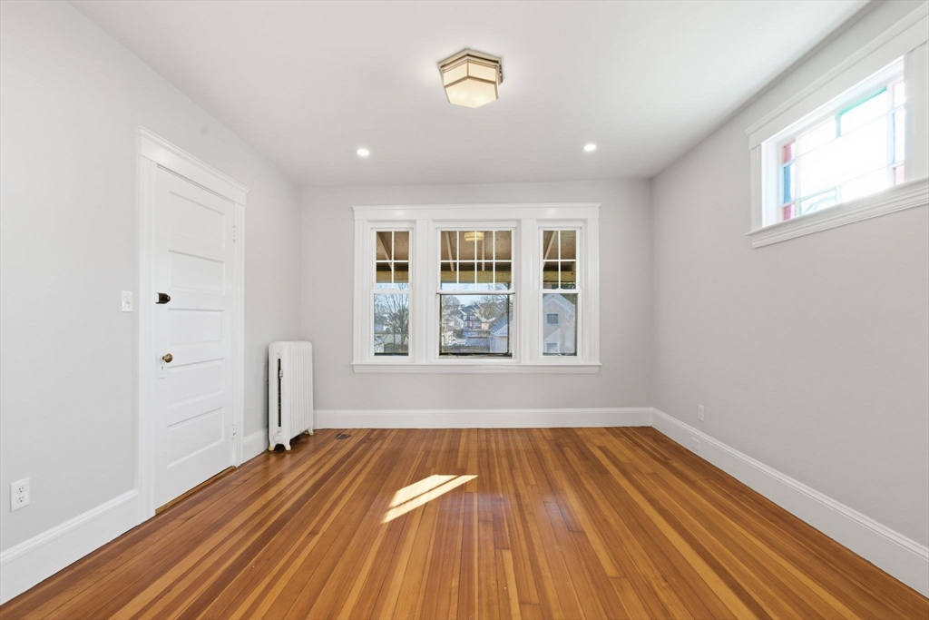 113 Minot Street, Unit 2 Boston, MA 02122 - Photo 27 of 34 a view of empty room with wooden floor and fan