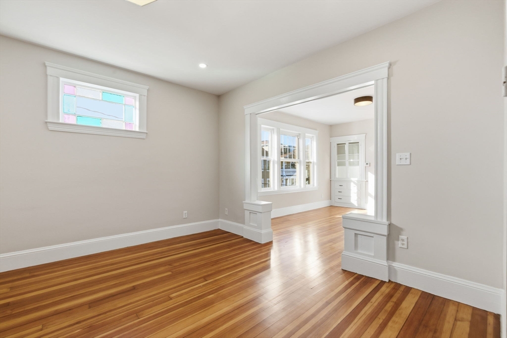 113 Minot Street, Unit 2 Boston, MA 02122 - Photo 31 of 34 a view of a room with wooden floor and window