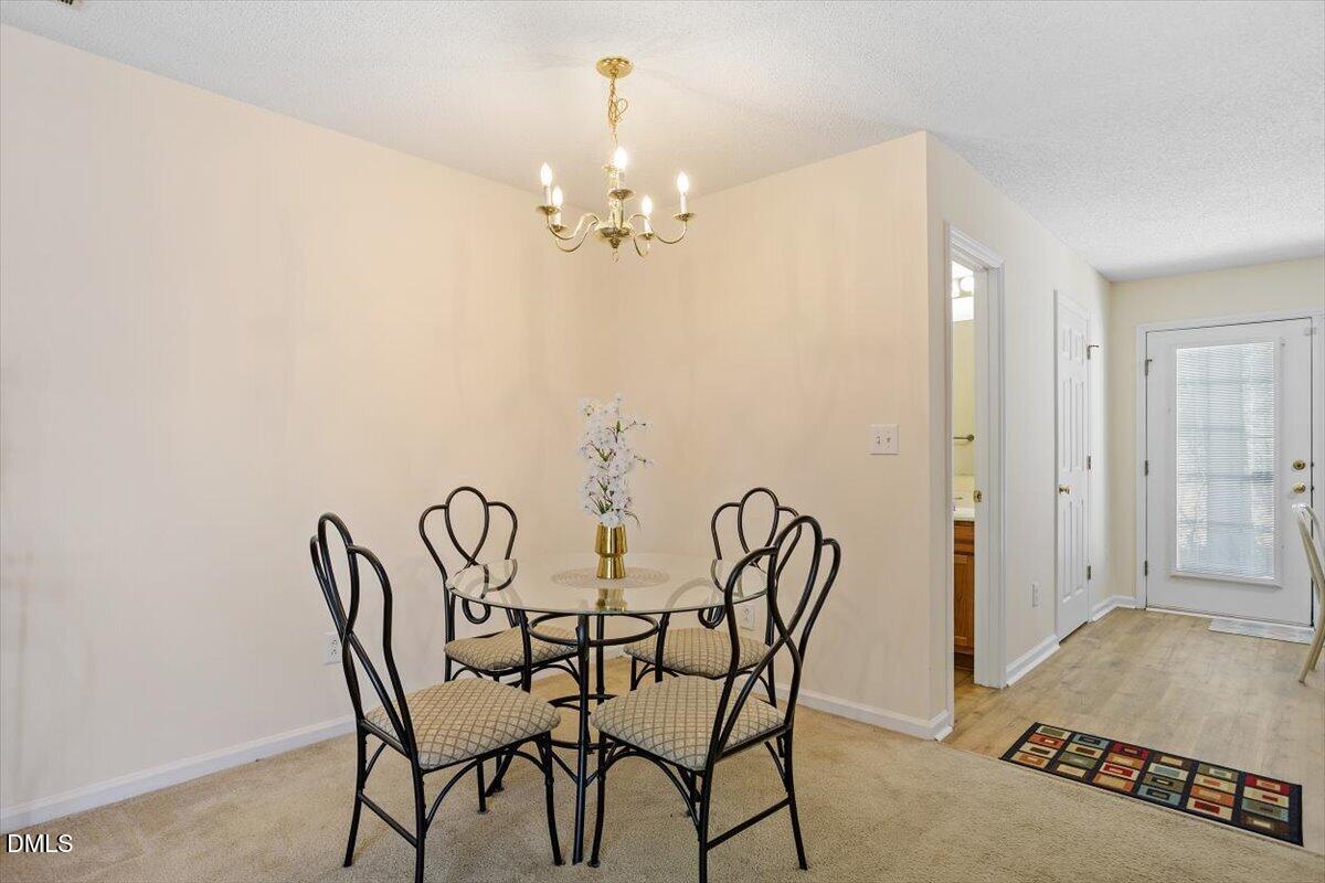 5503 Fieldcross Court Raleigh, NC 27610 - Photo 11 of 26 a view of a dining room with furniture and chandelier
