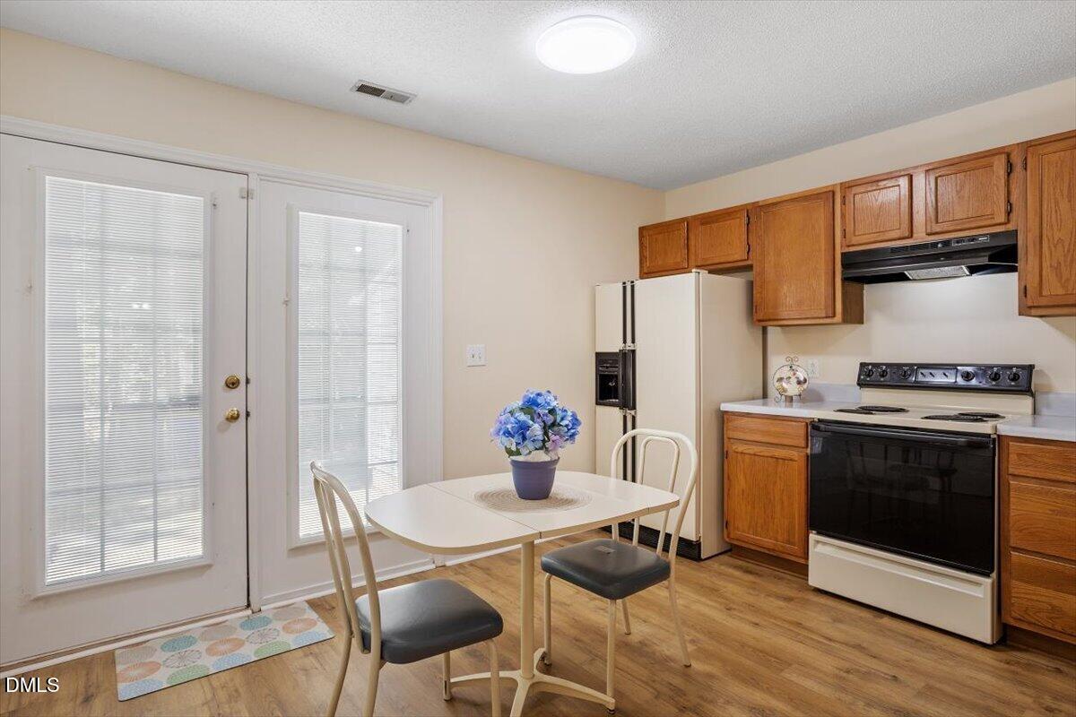 5503 Fieldcross Court Raleigh, NC 27610 - Photo 14 of 26 a kitchen with stainless steel appliances a dining table and chairs