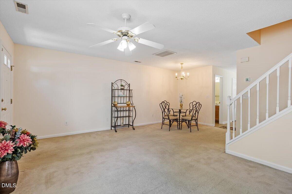5503 Fieldcross Court Raleigh, NC 27610 - Photo 7 of 26 a view of a room with gym equipment and a chandelier