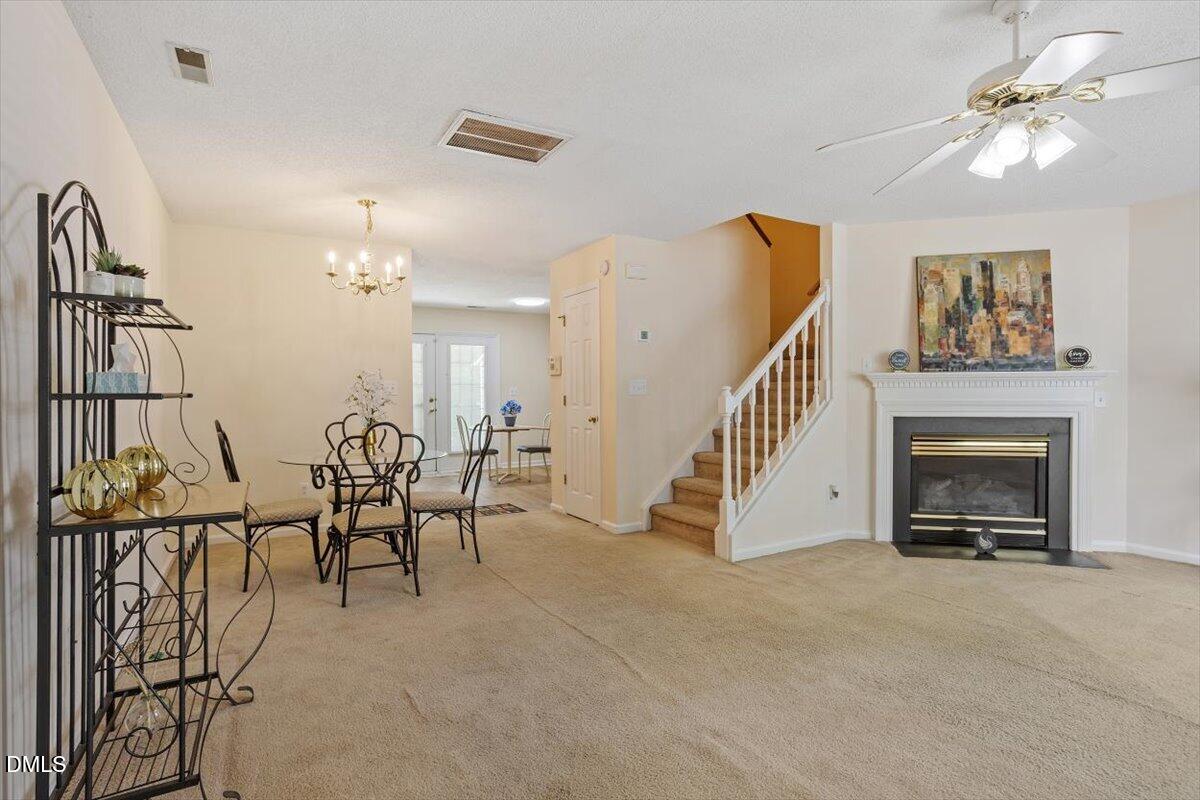 5503 Fieldcross Court Raleigh, NC 27610 - Photo 8 of 26 a view of a livingroom with furniture and chandelier fan