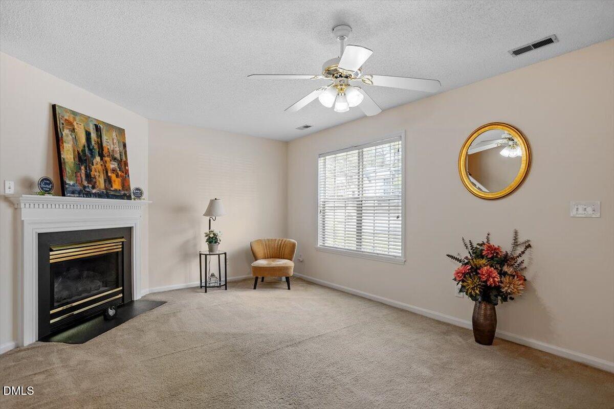 5503 Fieldcross Court Raleigh, NC 27610 - Photo 10 of 26 a view of livingroom with furniture chandelier fan and fire place