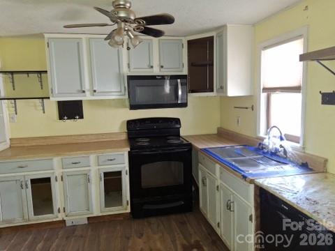 129 Harrison Street Swannanoa, NC 28778 - Photo 14 of 17 a kitchen with stainless steel appliances granite countertop a stove a sink and a microwave