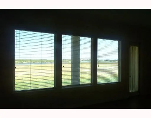 a view of an empty room with a city from balcony